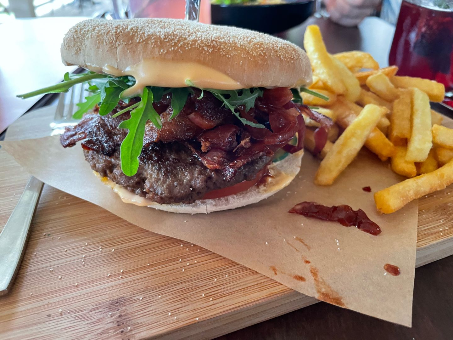 Close-up of burger and Fries on a wooden board